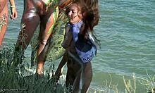 Tribal bodypaint hotties posing with swords and shit on a beach